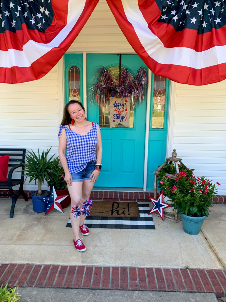 Arkansas lifestyle blogger, Amy, wears a blue and white July 4th outfit for women with red Keds