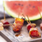 air fryer bacon wrapped watermelon on wood cutting board
