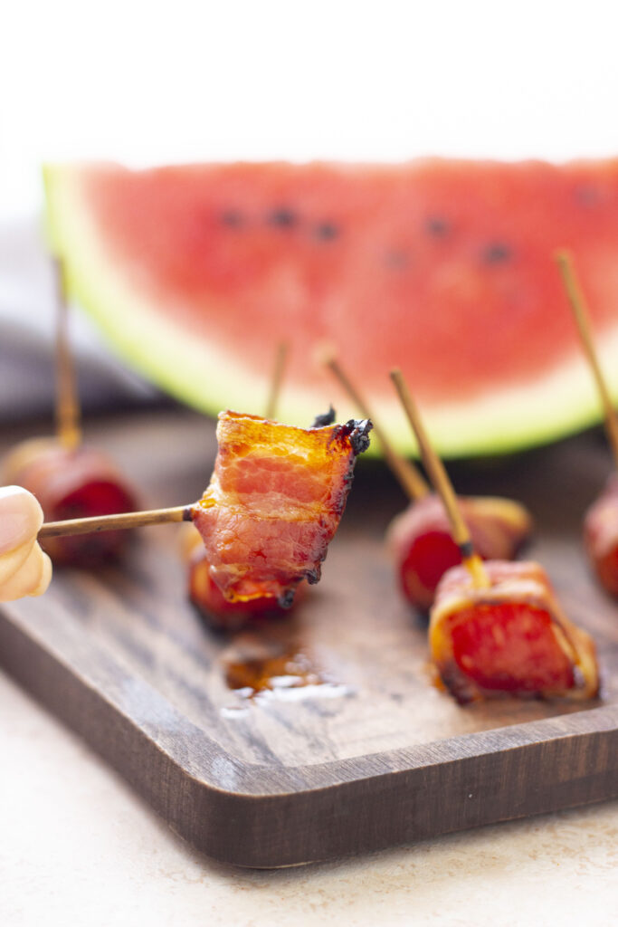 air fryer bacon wrapped watermelon on wood cutting board