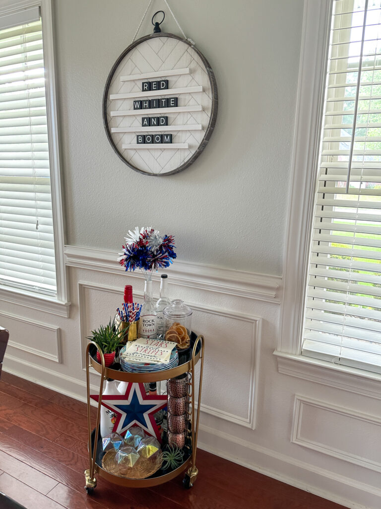 a styled patriotic bar car under at July 4th letter board sign