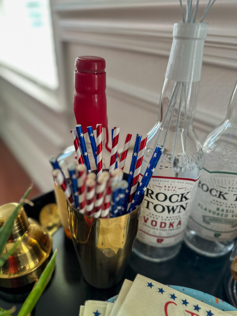 foil straws in a gold shaker cup