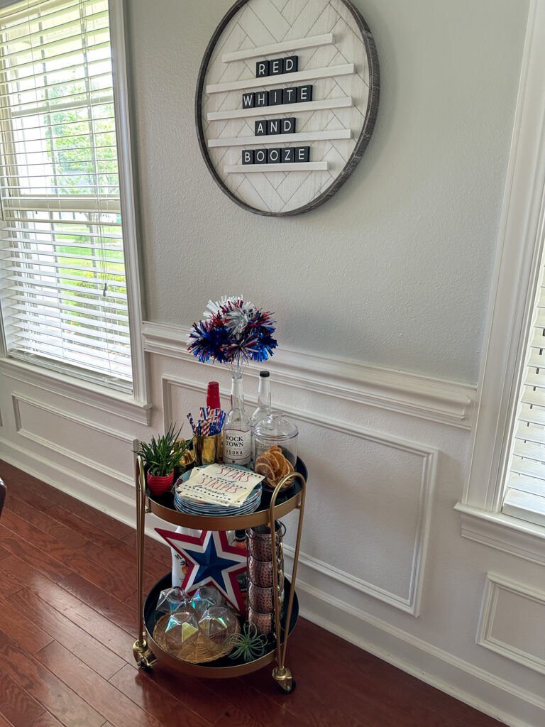 July 4th bar cart with red, white, and booze letter board hanging above