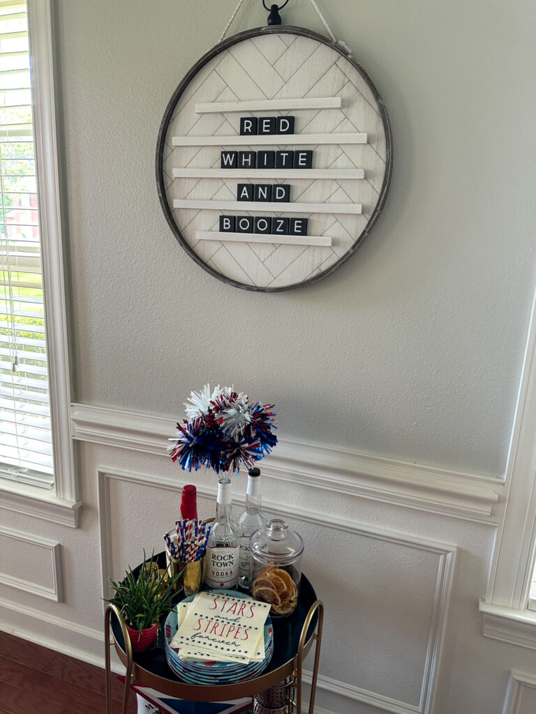 red white and booze letter board above bar cart