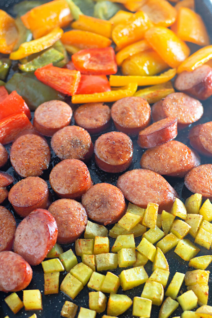 kielbasa sheet pan dinner with sausage in the middle and potatoes and veggies on the sides
