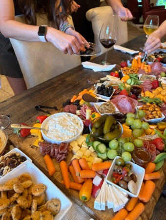 ladies eating from charcuterie board for ladies night in ideas