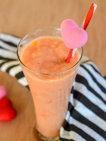 dairy free smoothie with orange juice and frozen fruit with a heart straw