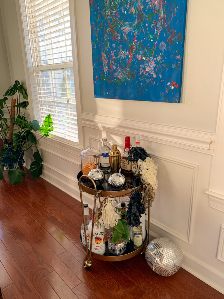 New Year's Eve bar cart under a big blue painting