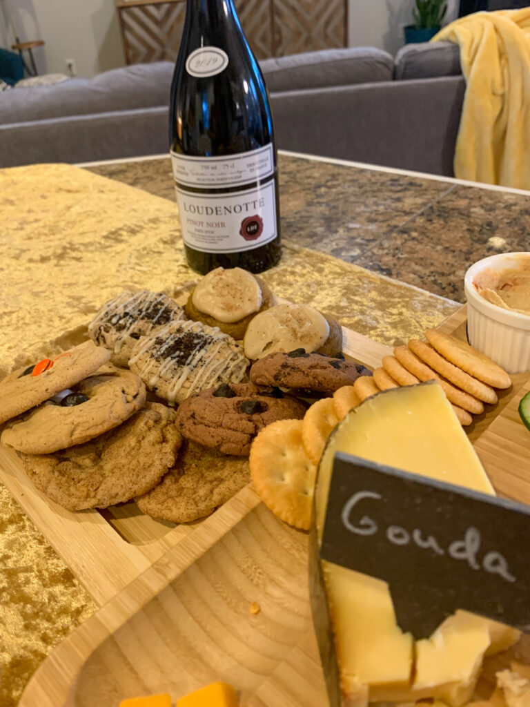 wine and cheese and tray of cookies at a wine and cheese party
