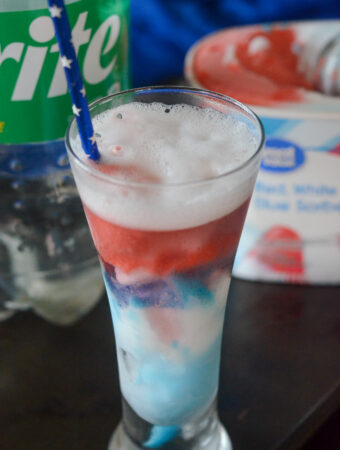 Sprite float with Great Value Red, White, and Blue Sorbet in front of sprite bottle and carton