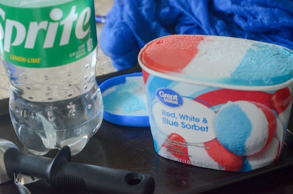 Great Value Red, White, and Blue Sorbet next to soda bottle