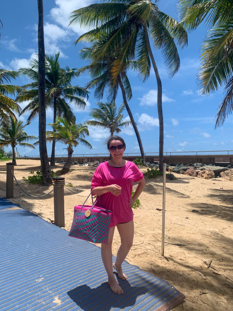 woman carries large beach bag on Condado Beach 