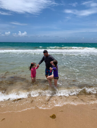 family in water at Condado Beach in San Juan