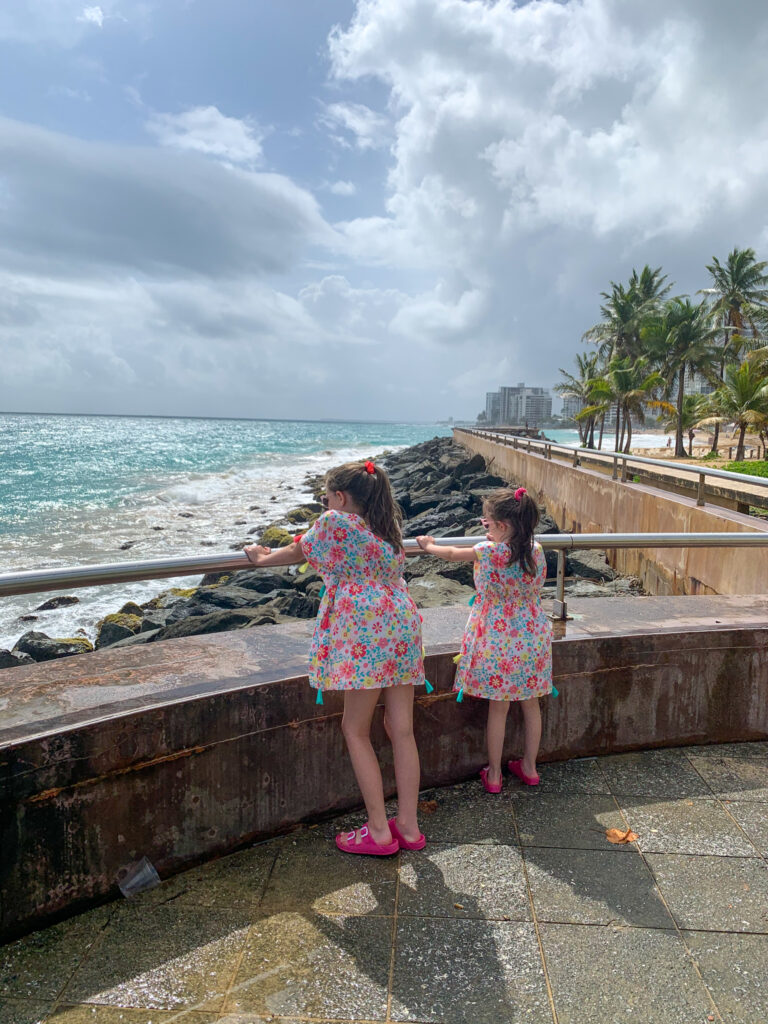 girls looking at the ocean at Condado Beach boardwalk area