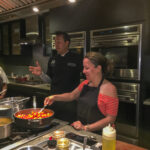 woman cooking during a cooking class at Savannah Cooking School at Forsyth Mansion for girls night out ideas