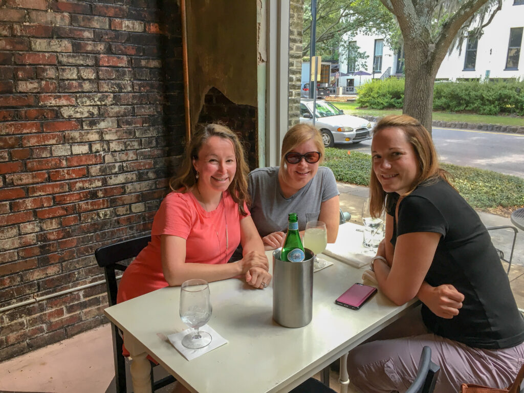three ladies sitting out a table for girls night out ideas