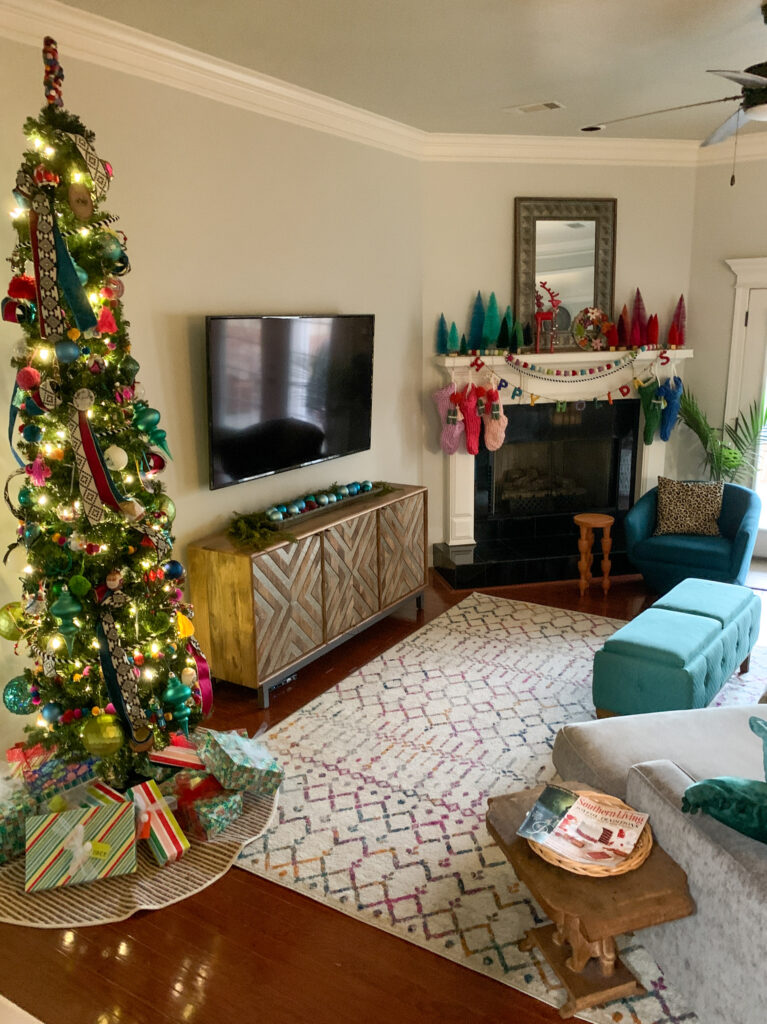 Merry and Bright Christmas decor in living room with Christmas tree on left