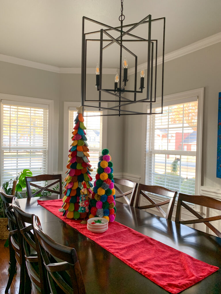 Merry and Bright Christmas decor - felt Christmas trees - on dining room table under large dining room fixture