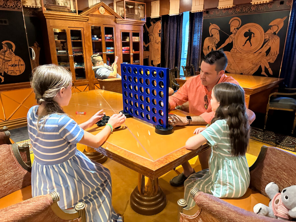 family plays games in Carnival Valor library room