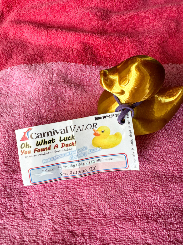gold cruising ducks with hang tag on pink towel from Carnival Valor cruise