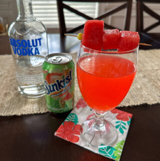 watermelon lemonade with vodka in glass on tropical napkin