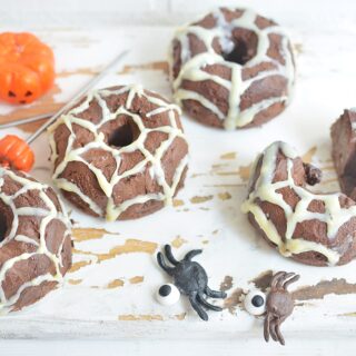 spider donuts on white counter with spiders and pumpkins