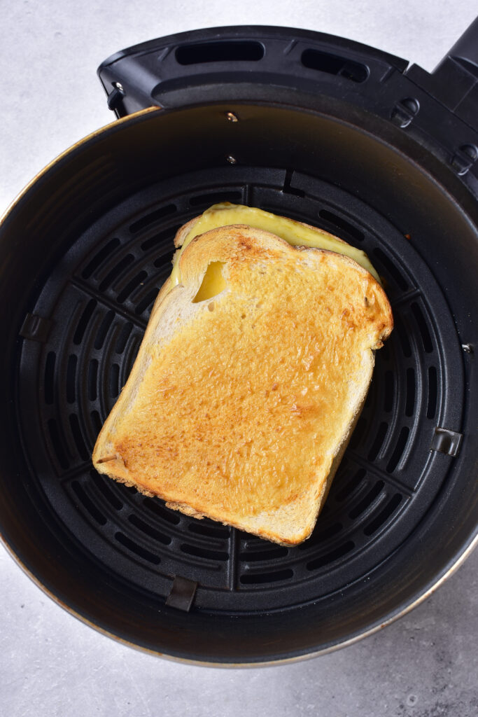 air fryer cheese toastie with golden spread on top