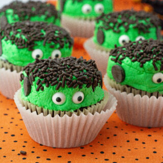 Frankenstein cupcakes in a row on polka dot tablecloth