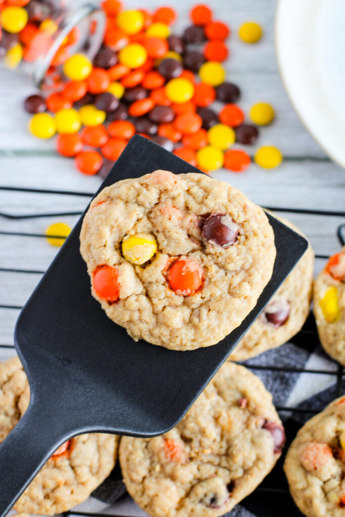 Reese's Pieces peanut butter cookies with one on spatula