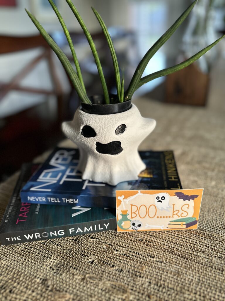 A BOOkish boo box gift for the You've Been BOOked game with a ghost plant and a stack of books and free Halloween book gift tag