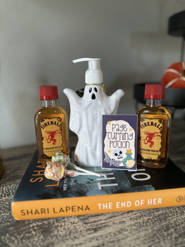 items from a You've Been BOOked Halloween gift for book lovers - including a ghost soap, Fireball whisky, lollipops and a book