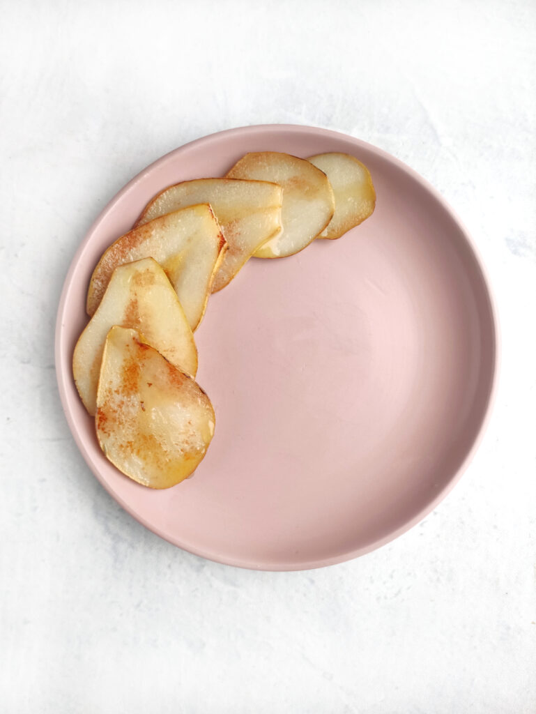 caramelized pears on pink plate