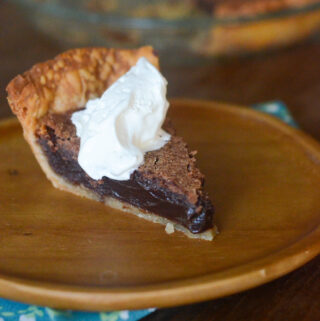 slice of chocolate chess pie on a bamboo serving plate