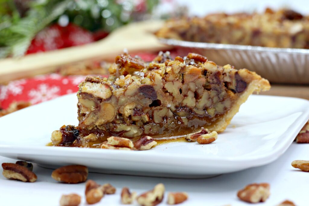 salted pecan turtle pie piece on a white serving plate