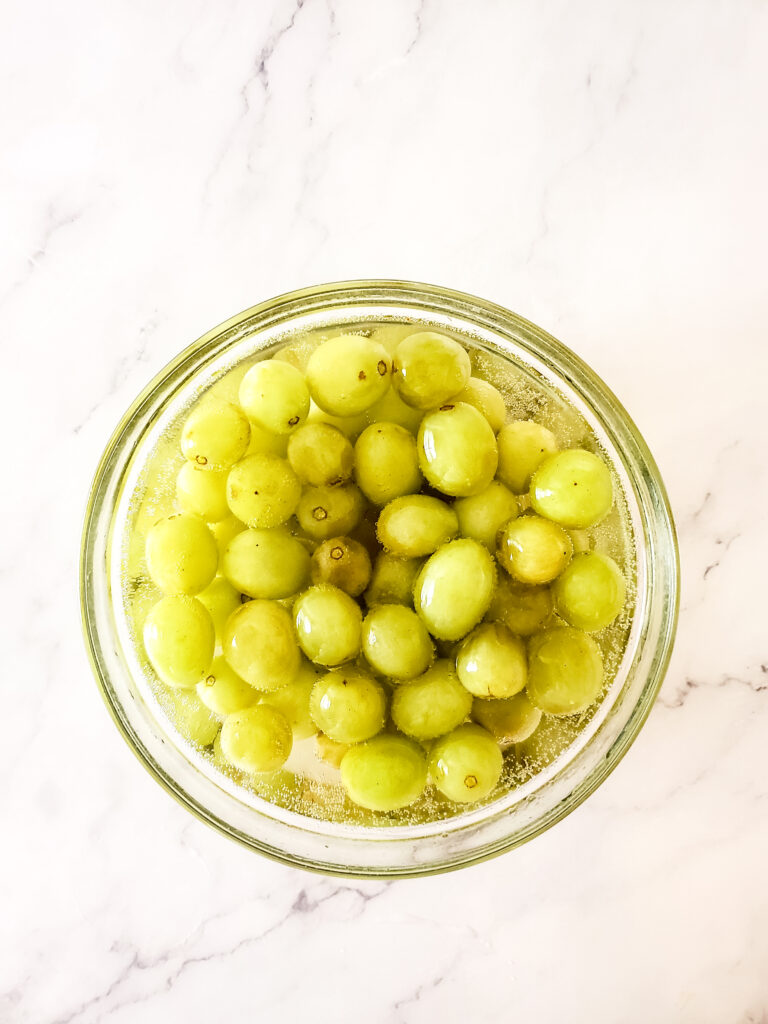 grapes in champagne in glass bowl