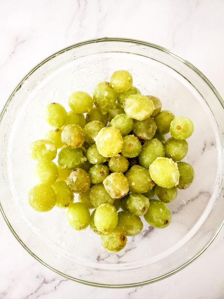 frozen sugared grapes in wine in glass dish