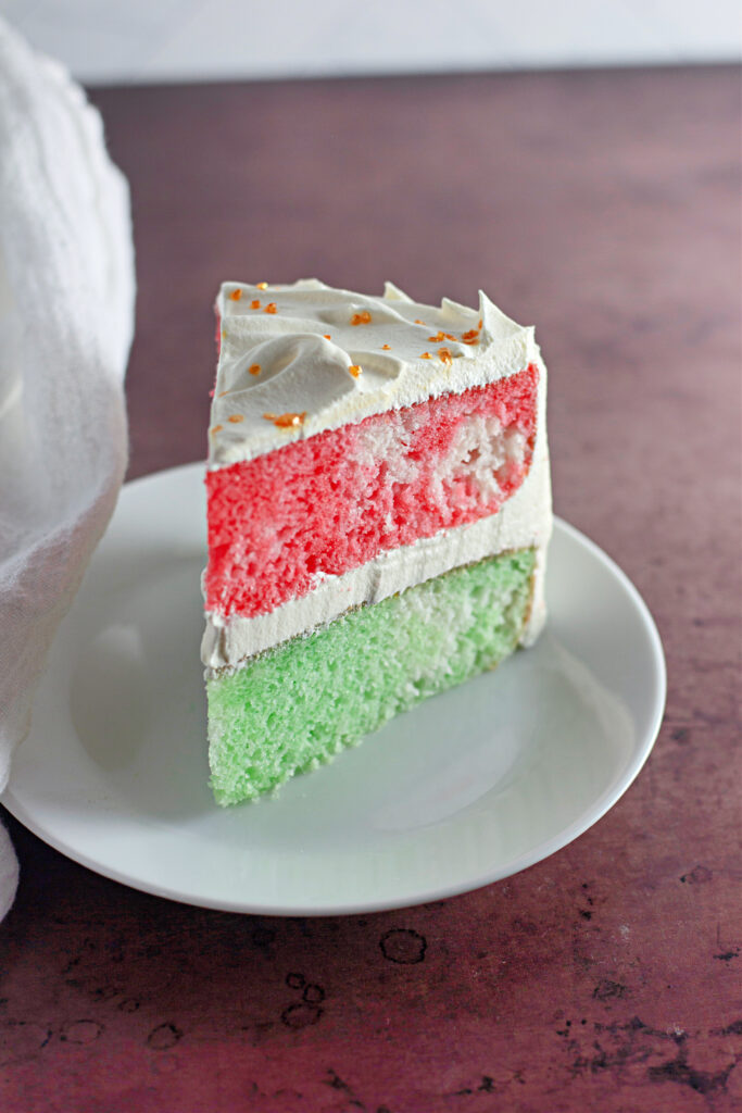 slice of layered Christmas Jello cake on white plate