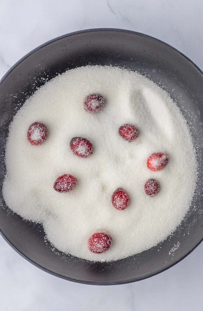 sugared cranberries in bowl of sugar