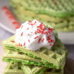green Grinch waffles stacked for a Grinch breakfast