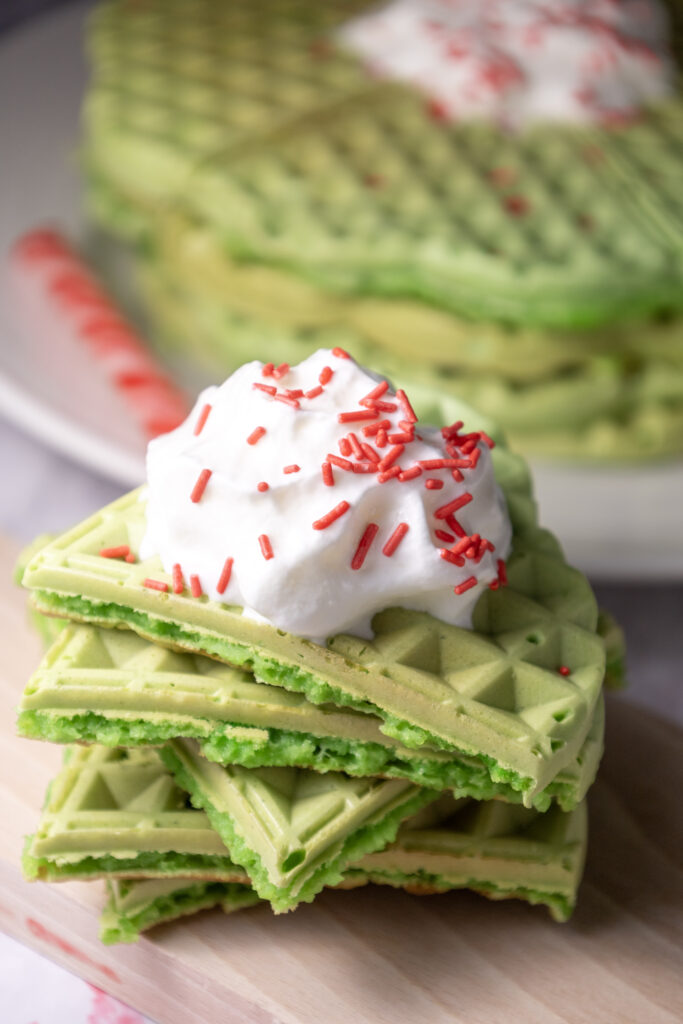 green Grinch waffles stacked for Grinch breakfast ideas for Christmas