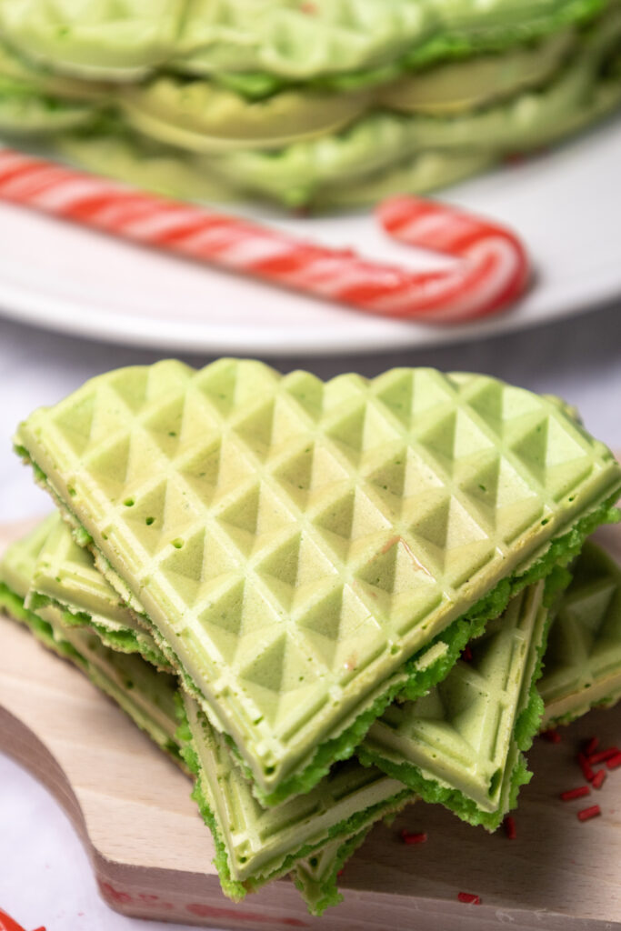 green waffles stacked on plate for Grinch breakfast or St. Patty's Day breakfast