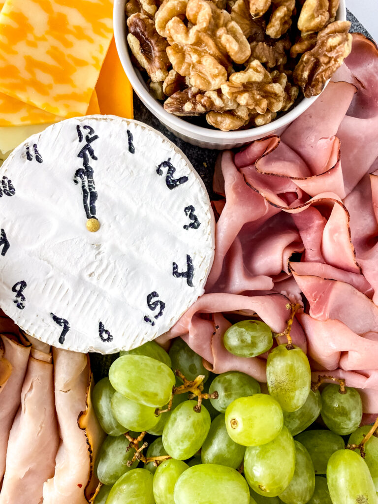 New Year's charcuterie tray with cheese clock