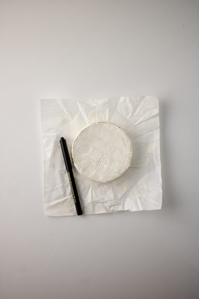 edible pen and brie cheese round