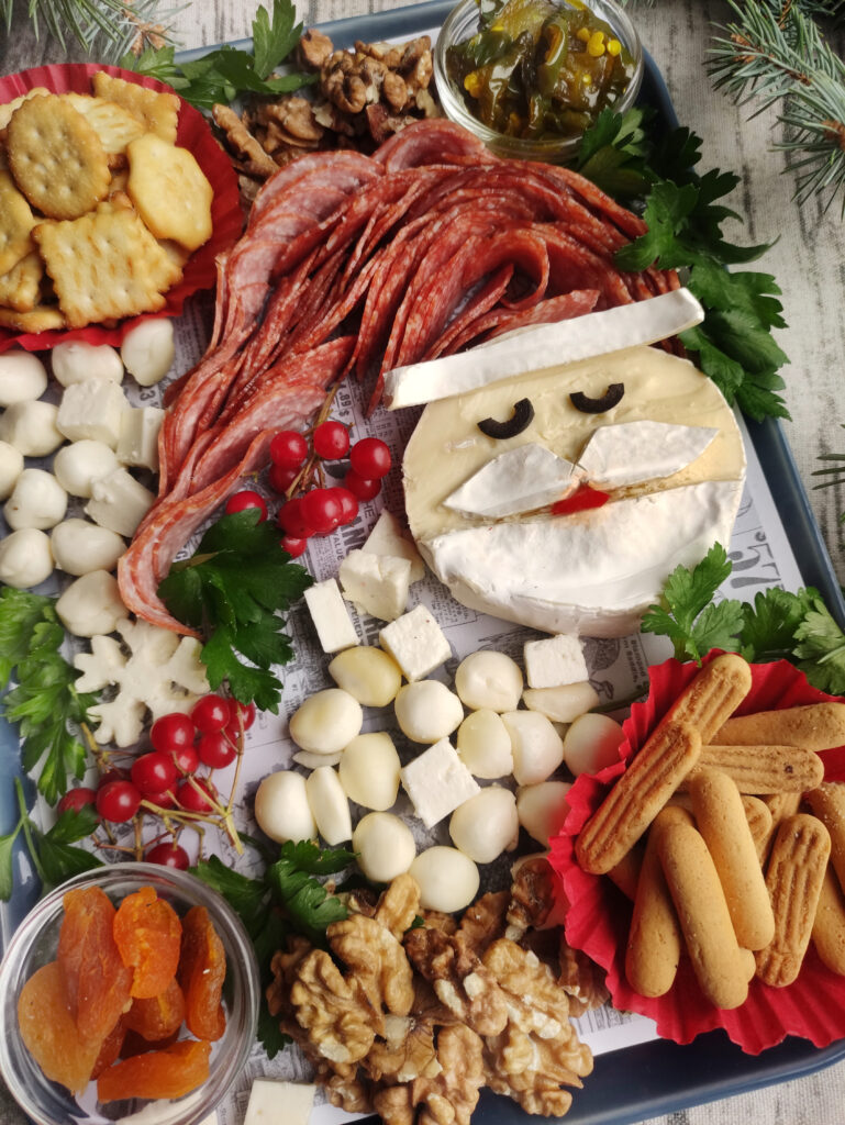 Santa charcuterie board with crackers and cheese