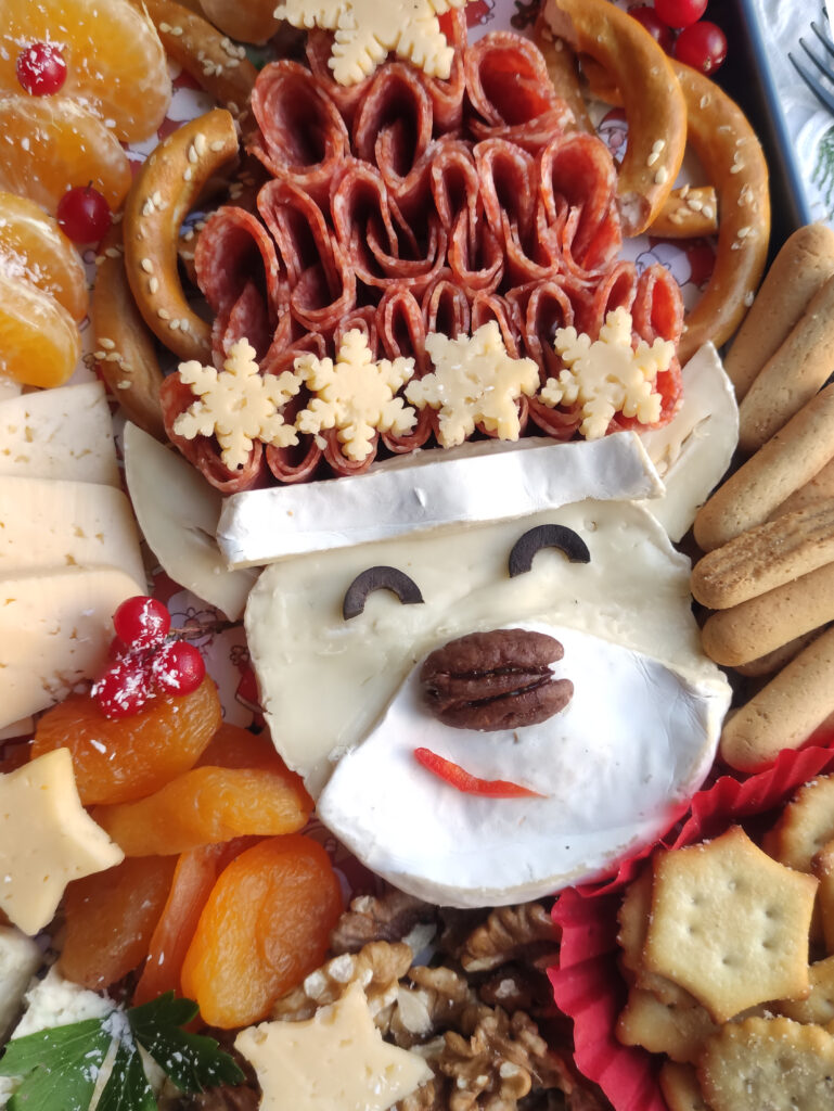 up close of reindeer charcuterie board with fruit and cheese