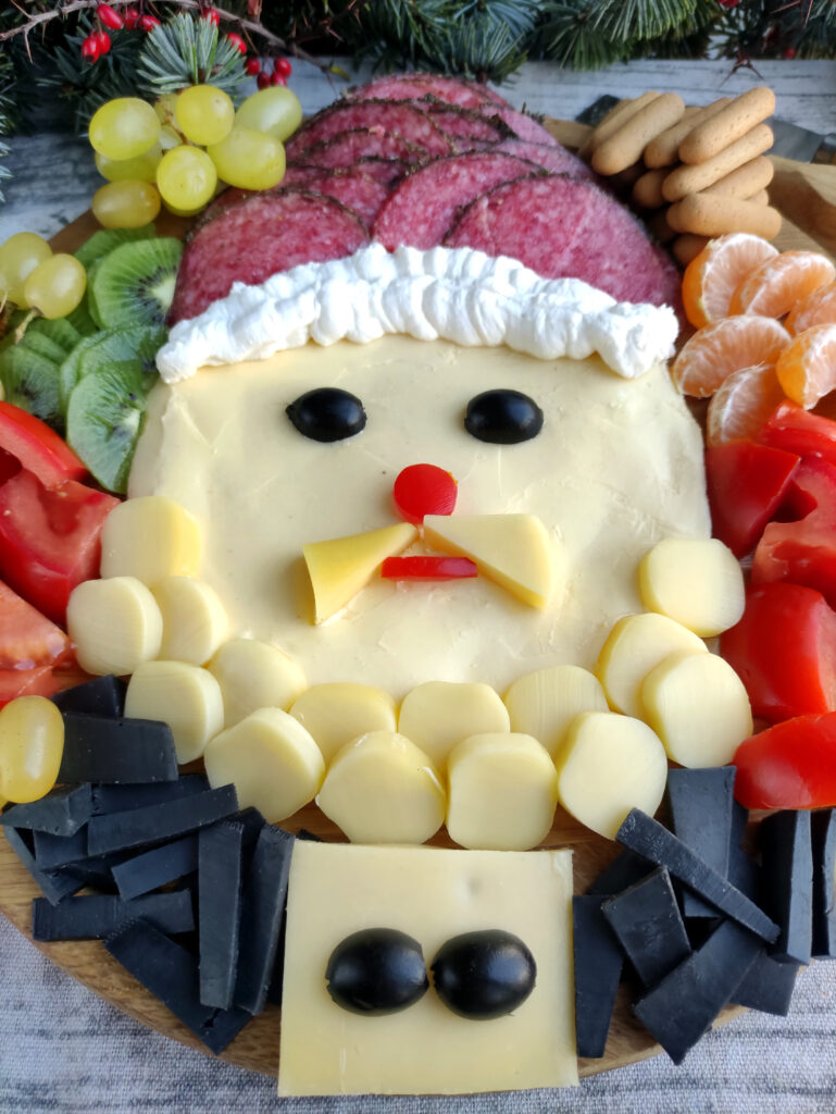 Christmas butter board with Santa surrounded by fruit