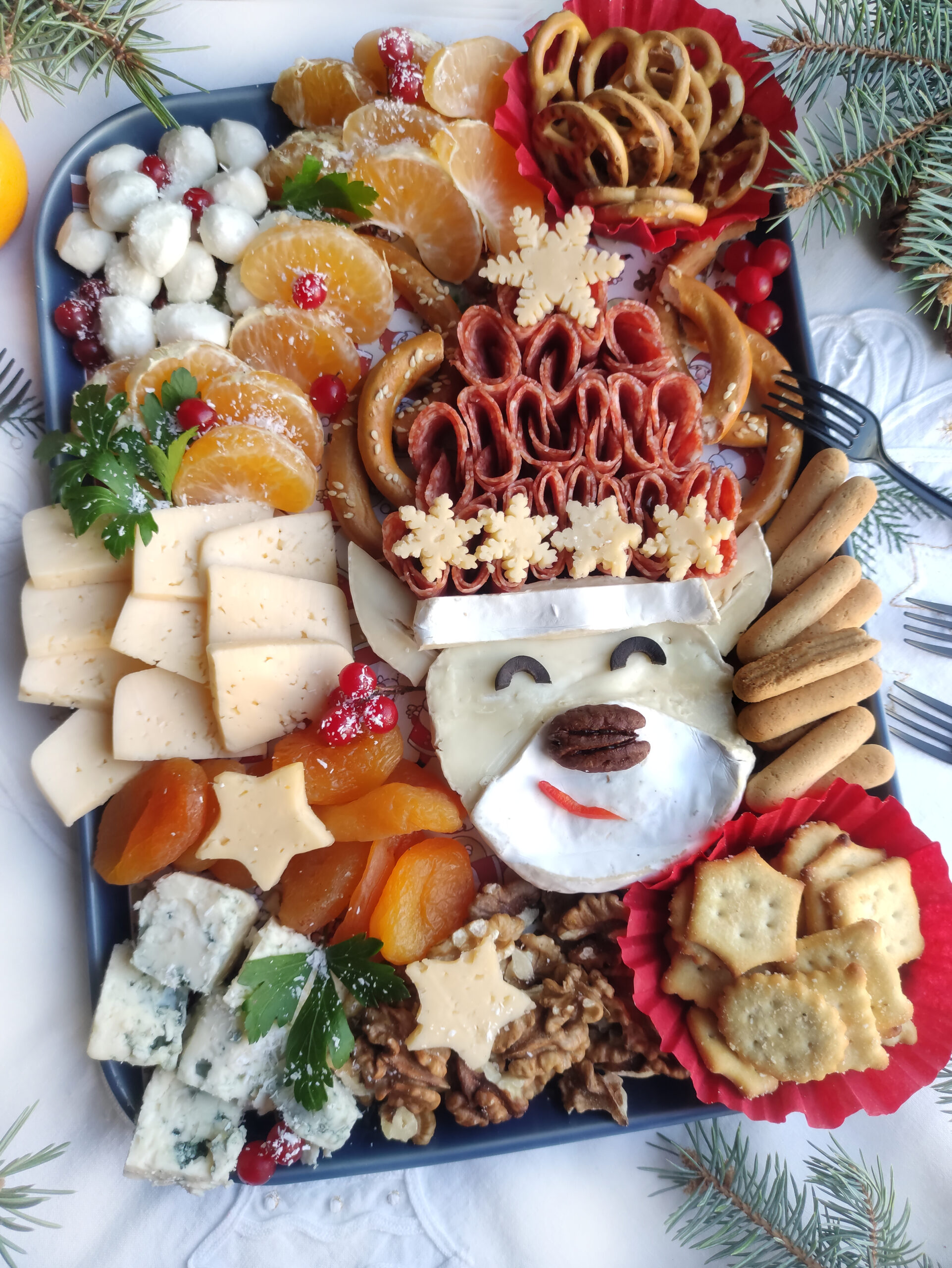 reindeer charcuterie board with meat and cheese with forks to the side
