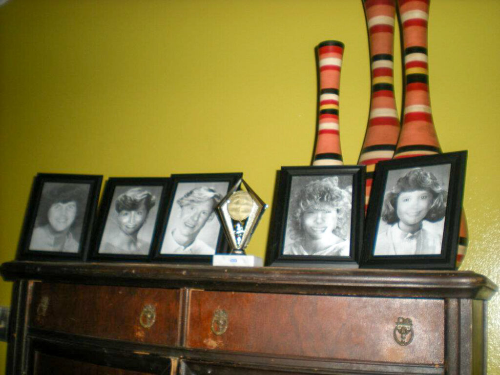 old pictures on a mantle an an 80s theme murder mystery party