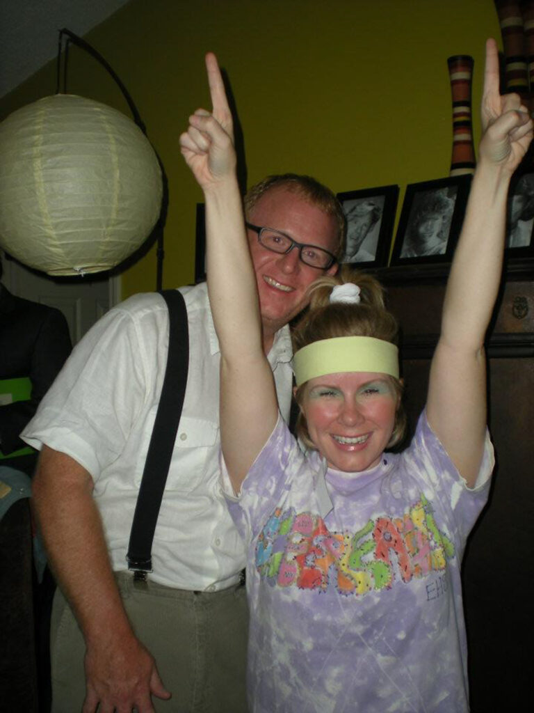 couple in costume at 1980s murder mystery party