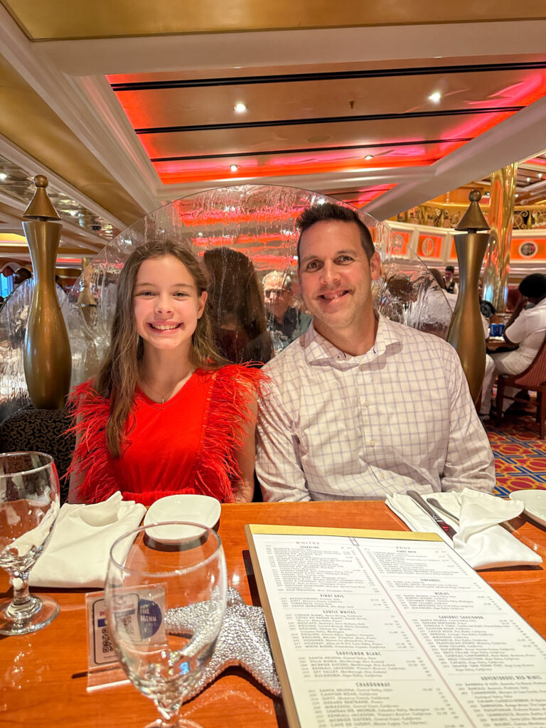 daughter and dad at table in the Lincoln Dining Room on Carnival Valor Cruise