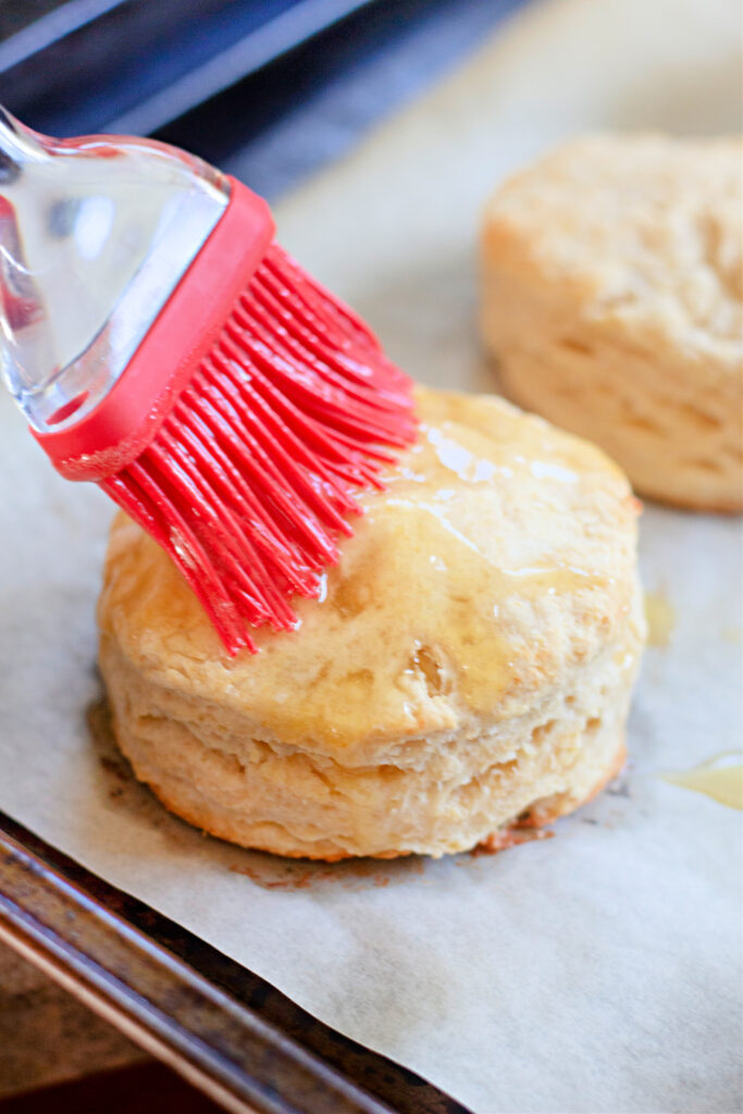 brushing honey butter biscuits